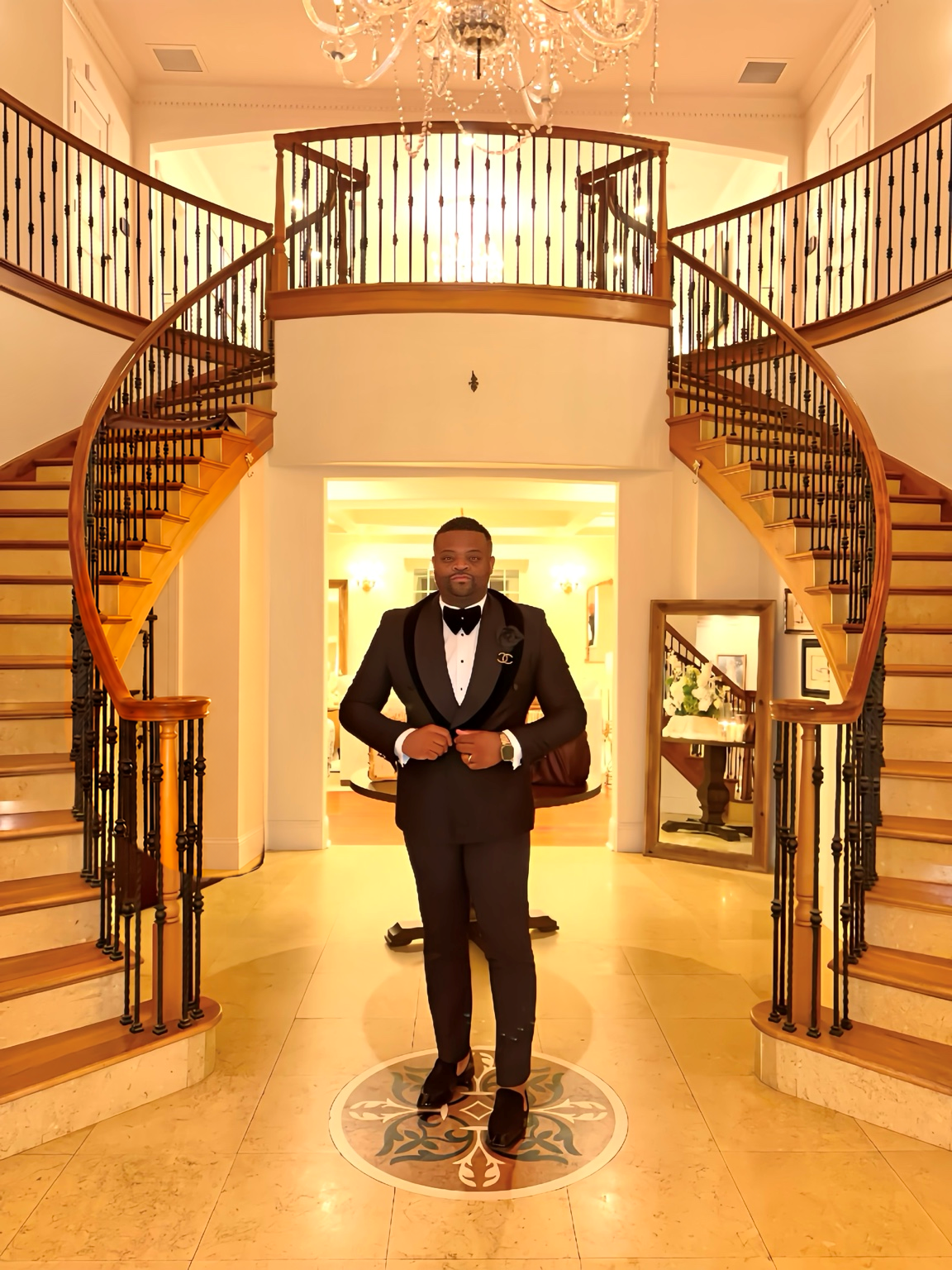 Rob Daies in formal attire on grand staircase